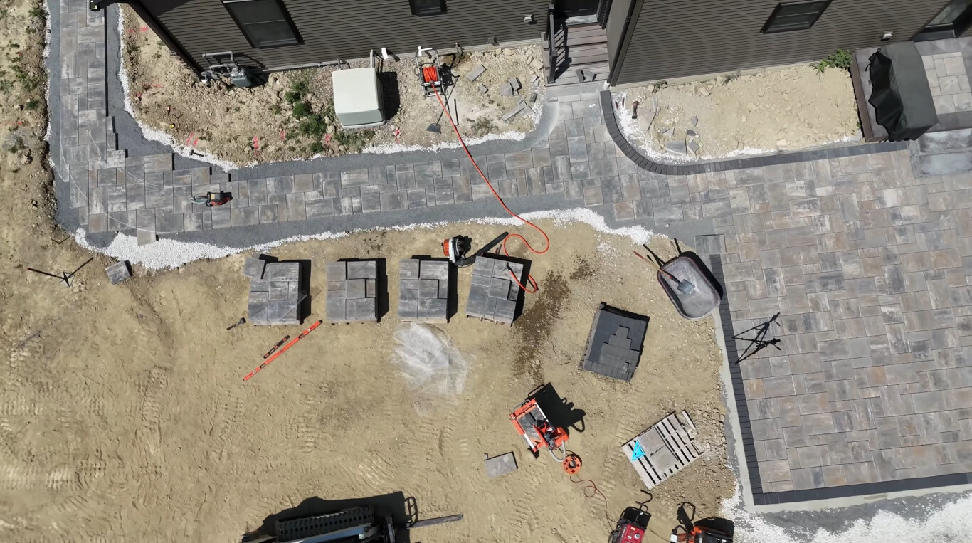 Aerial view of concrete walkway installation in progress at a residential property